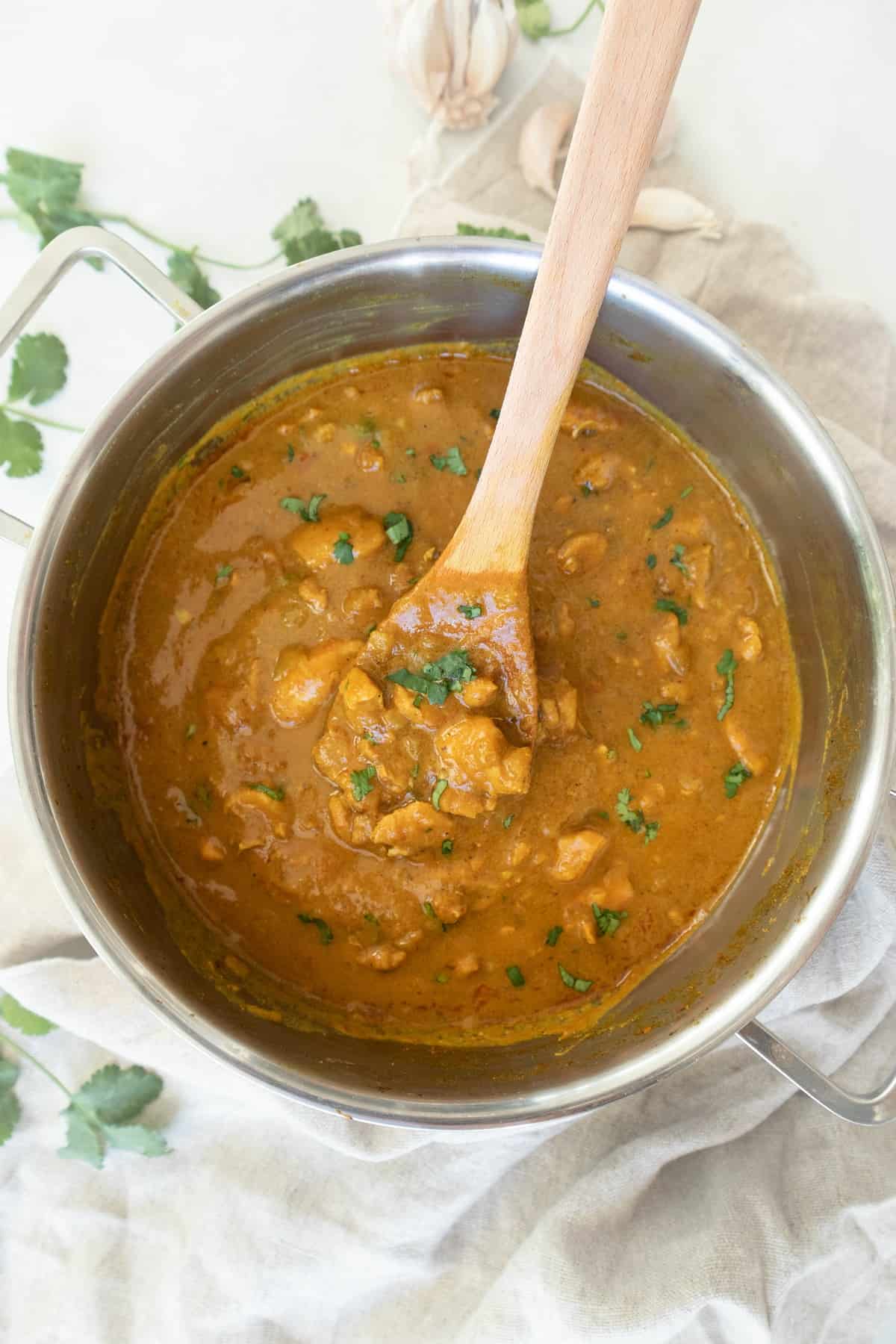 Boneless mango chicken curry with coconut milk on large pot