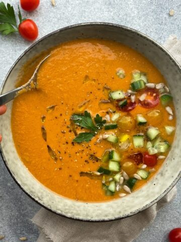 Authentic spanish gazpacho on a bowl with diced veggies on top