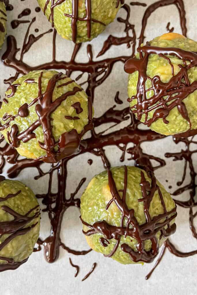 Matcha coconut truffles with melted dark chocolate on top
