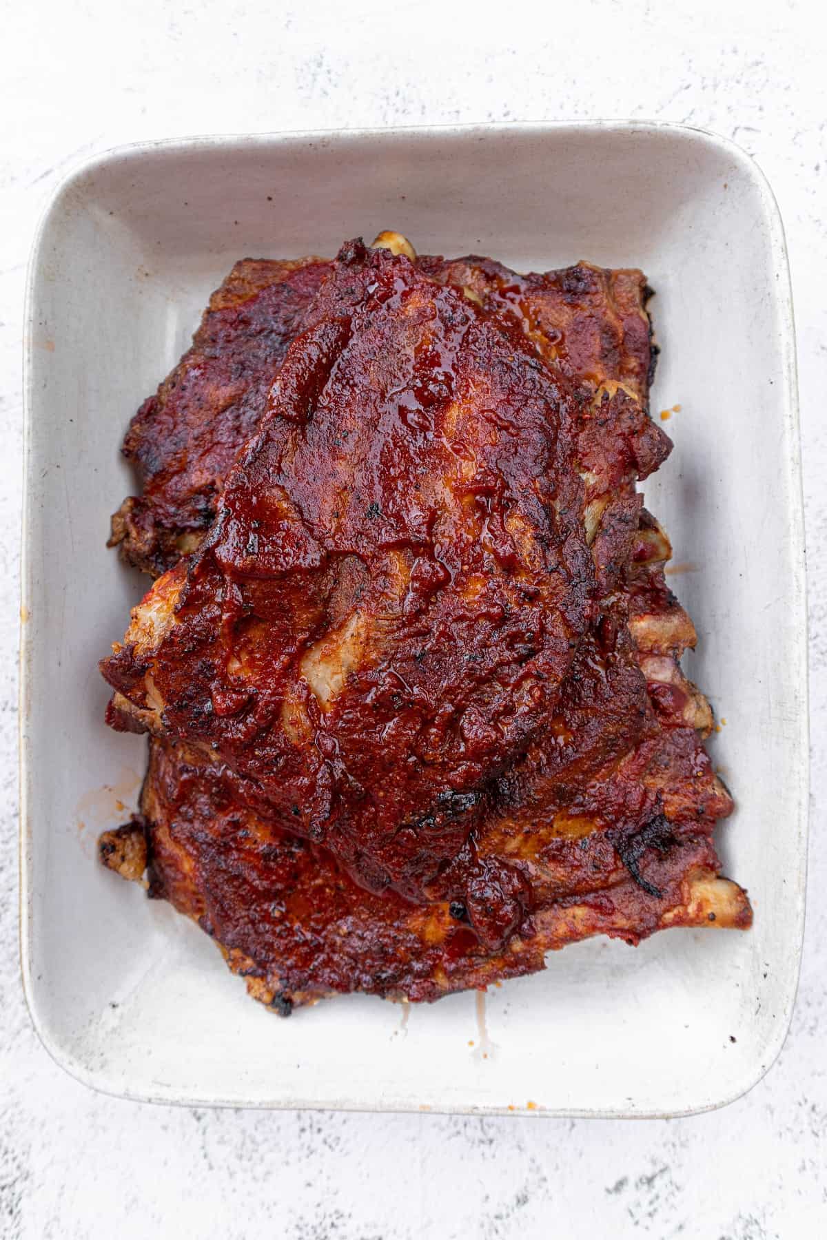 Fall off the bone BBQ pork ribs on ceramic tray