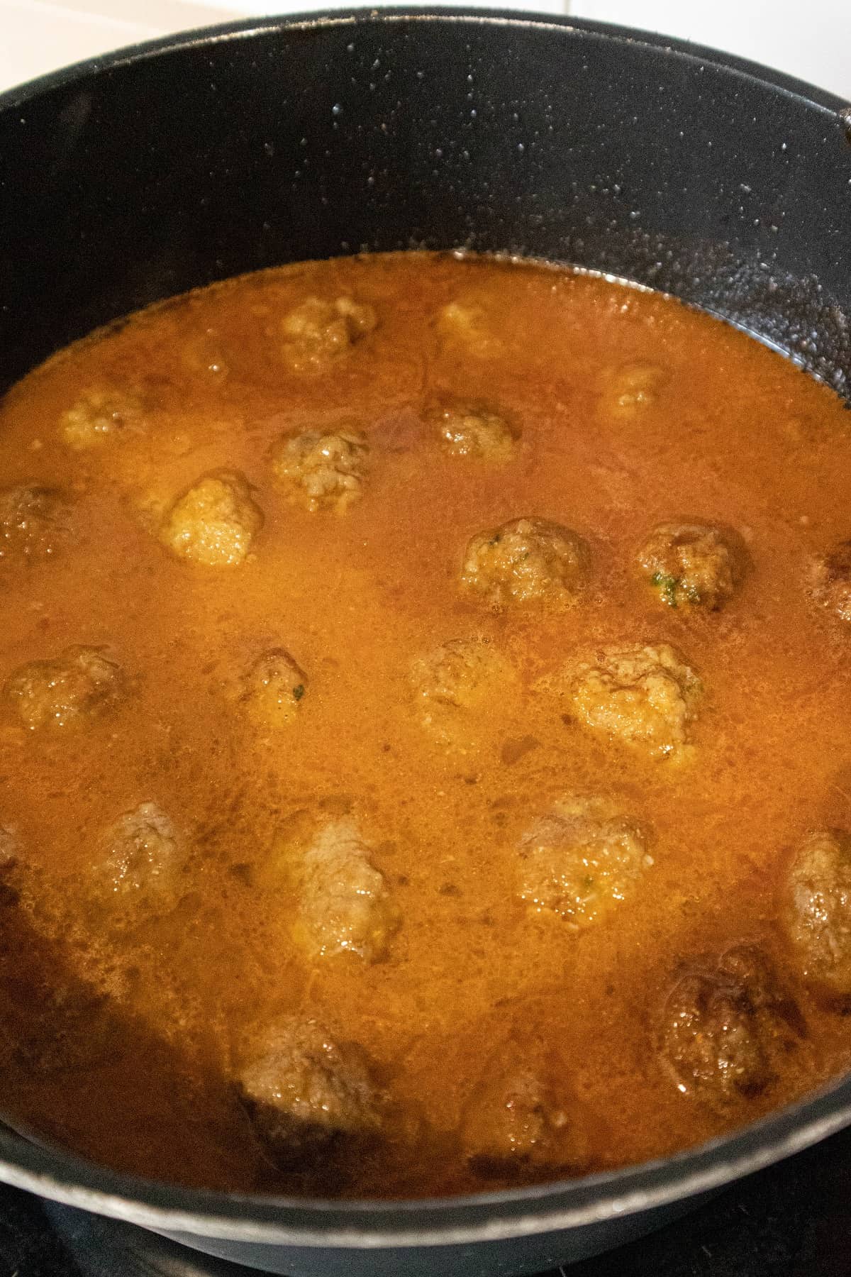 Add the meatballs to the tomato onion sauce