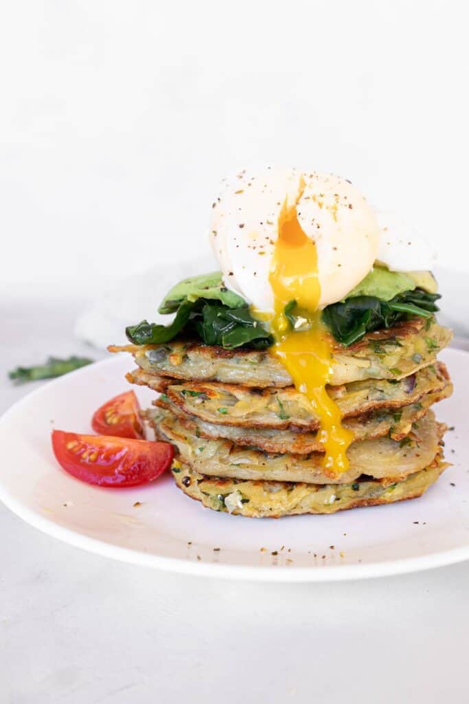 Potato fritters (gluten-free) stacked with spinach, avocado and poached egg