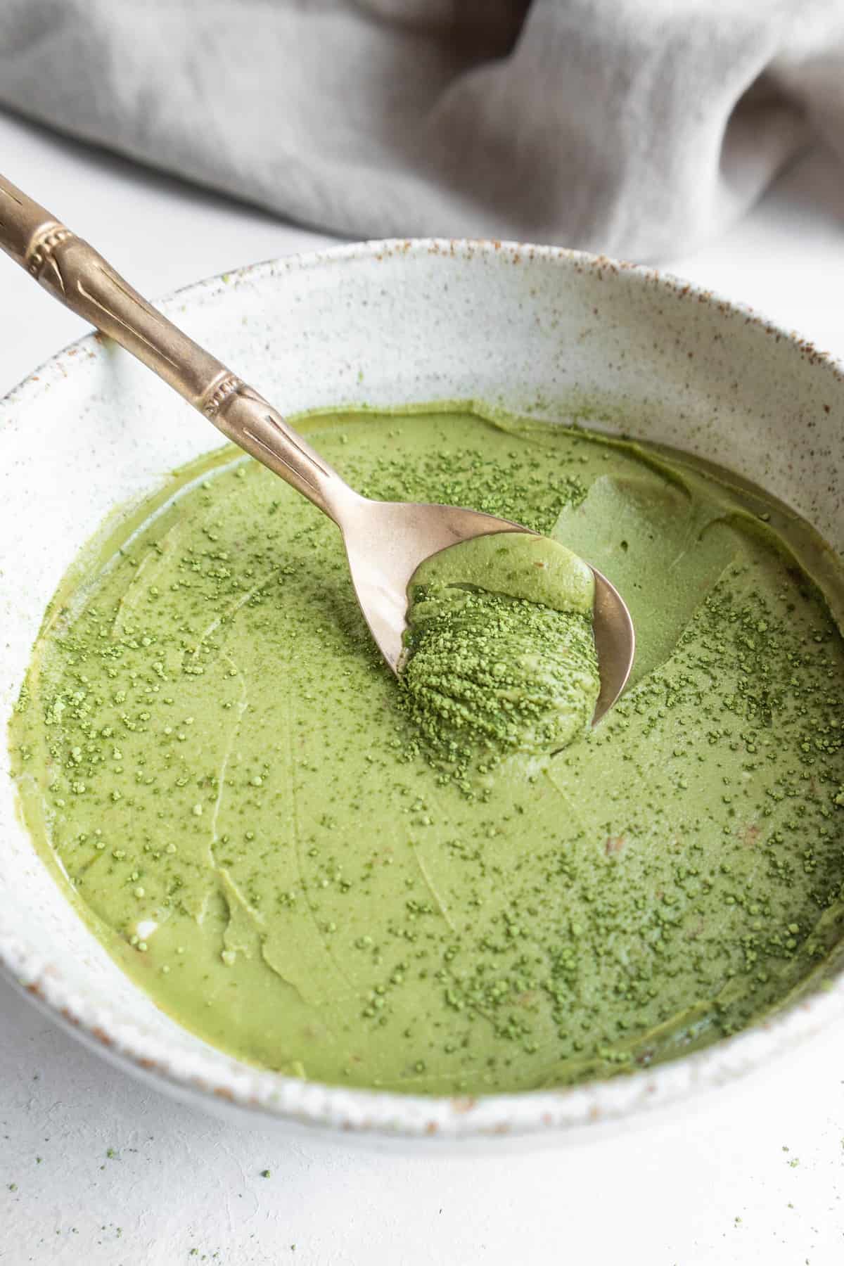 Matcha mousse in a bowl with a spoon