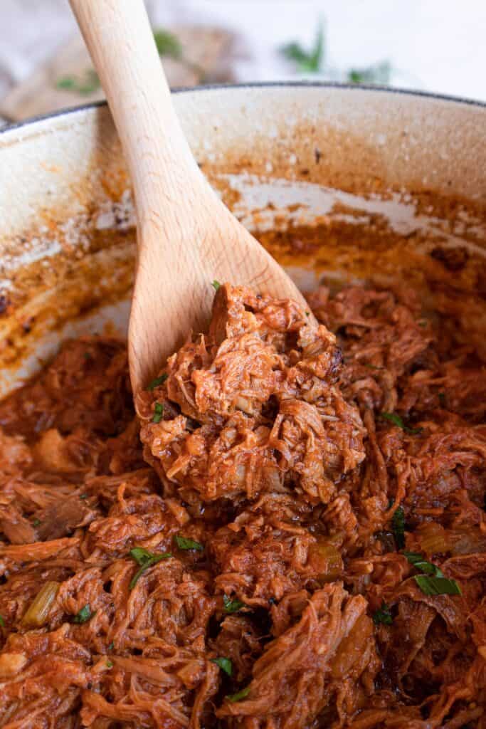 Dutch oven with bbq pulled pork and spatula