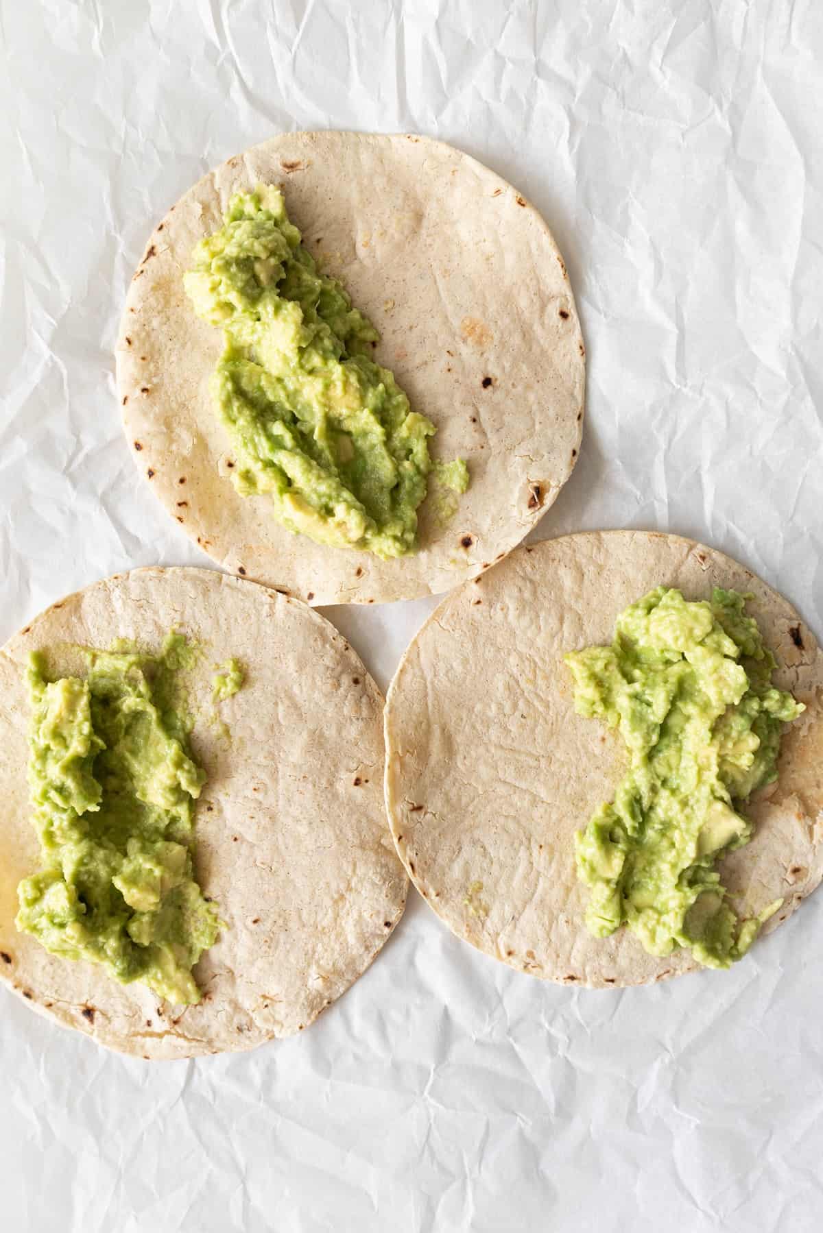 heated tortillas with avo mash on top