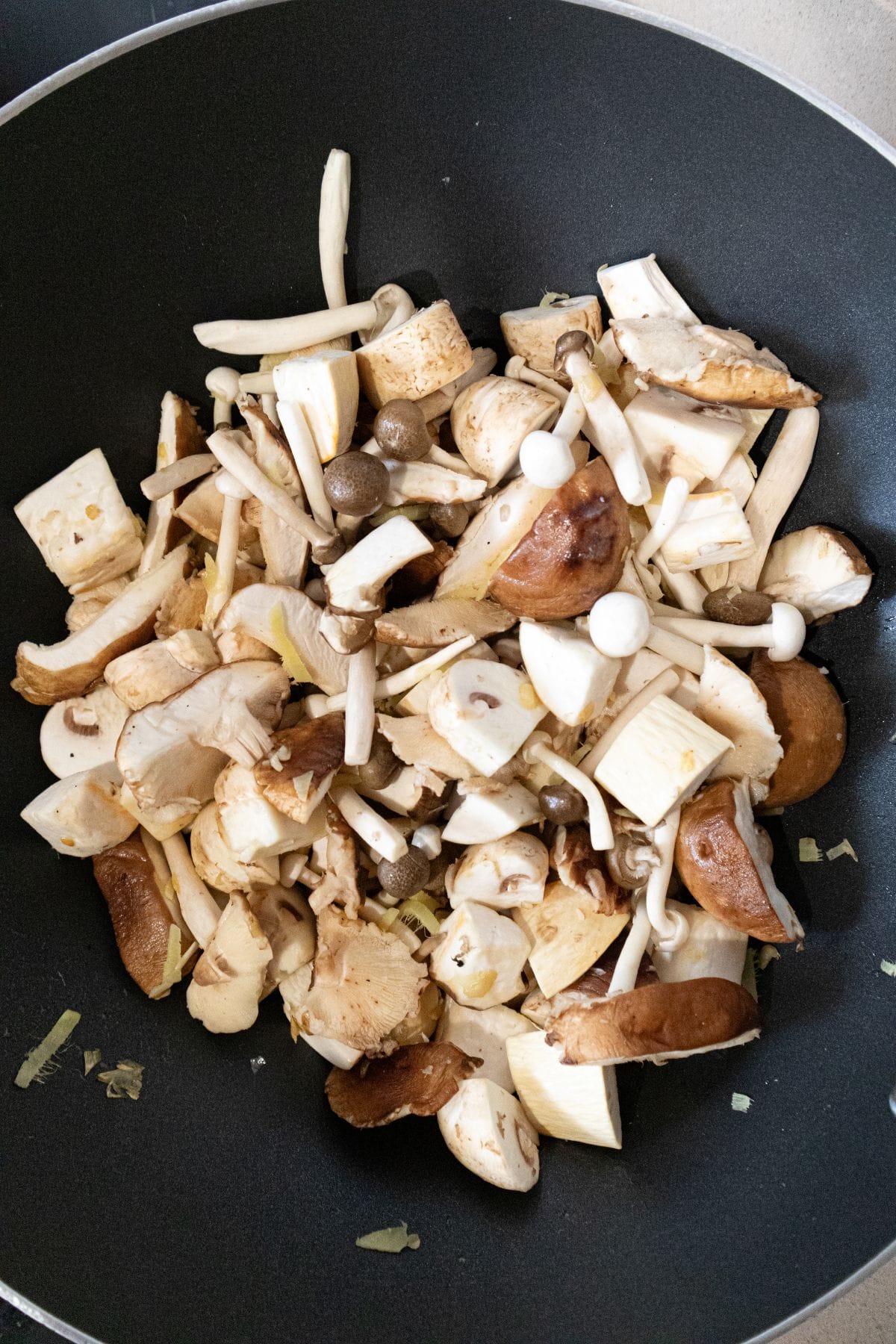 Stir frying the mushrooms with the ginger and garlic
