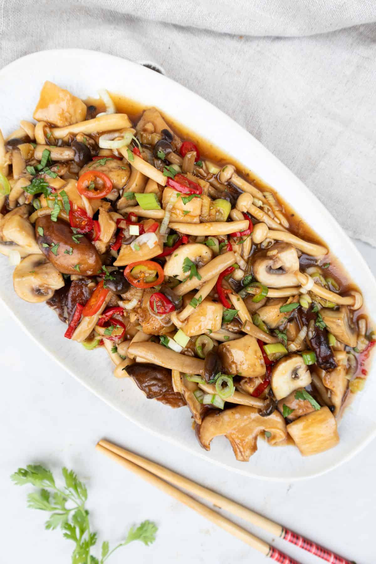 Thai mushrooms stir-fry served on an oval plate