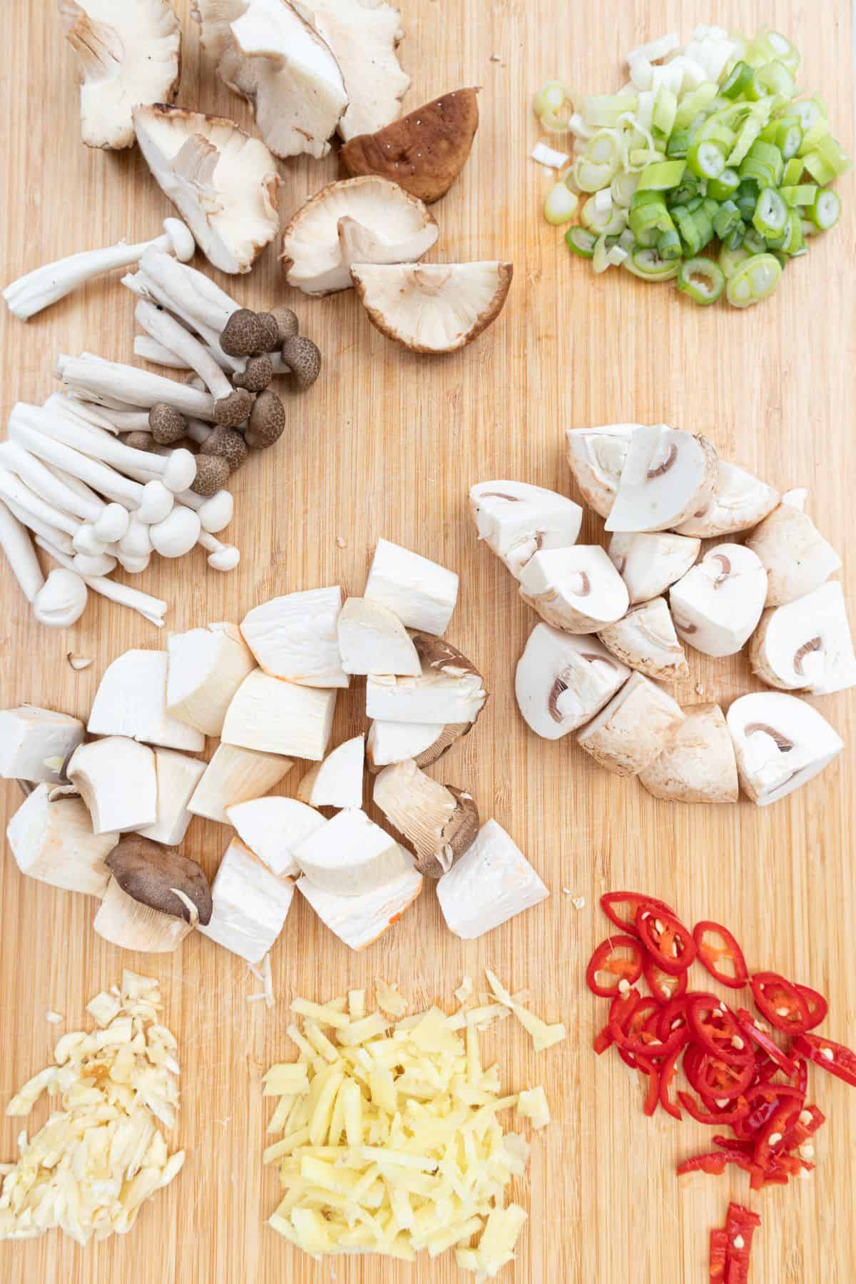 mushrooms and veggies cut on chopping board