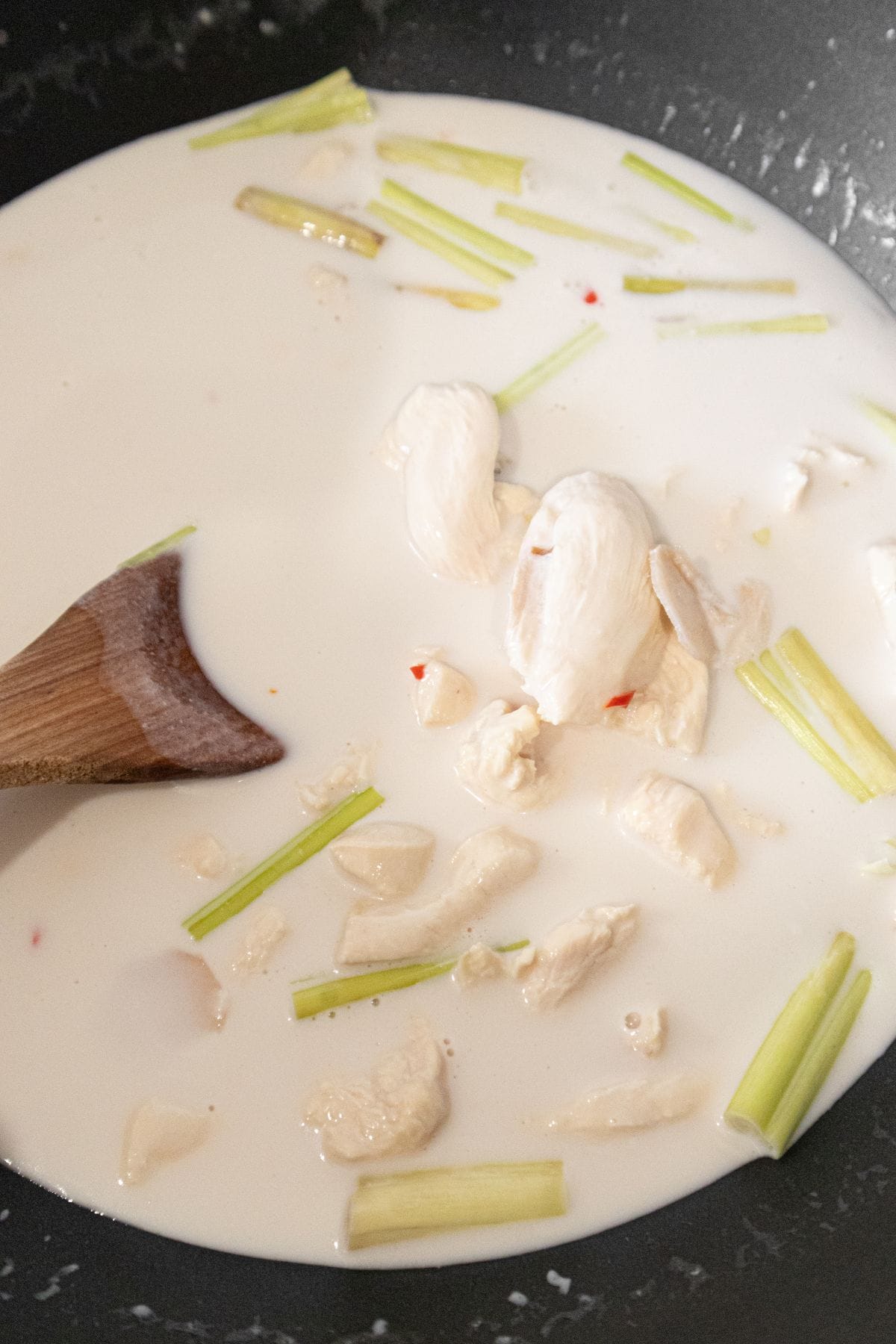 Chicken slices added to coconut chicken broth