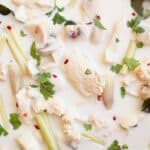 Close up of Thai coconut lime chicken served with plain rice and fresh cilantro