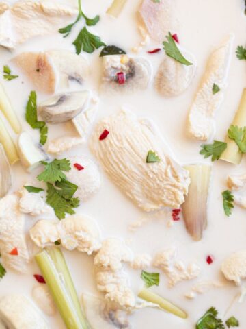 Close up of Thai coconut lime chicken served with plain rice and fresh cilantro