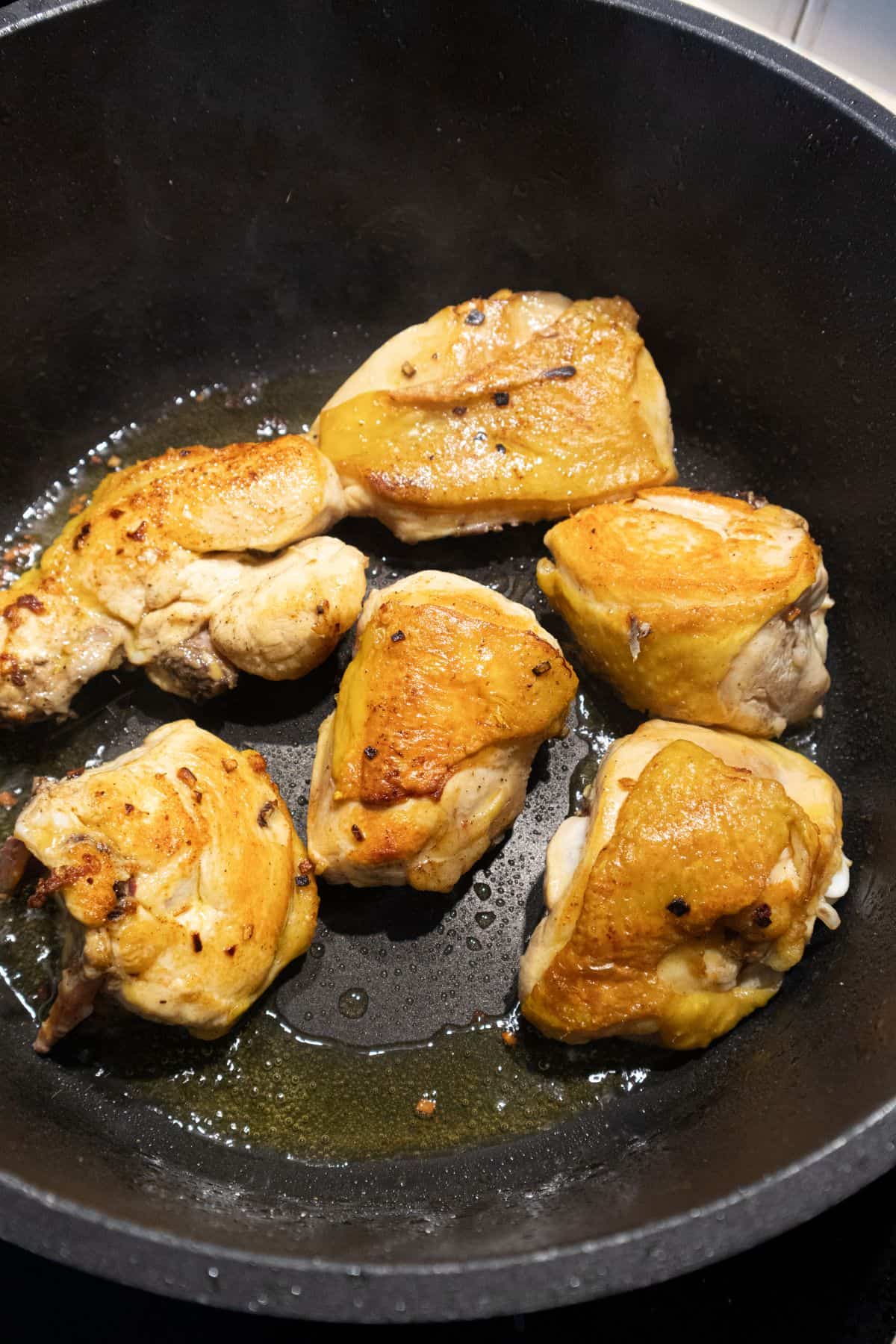 Chicken pieces searing