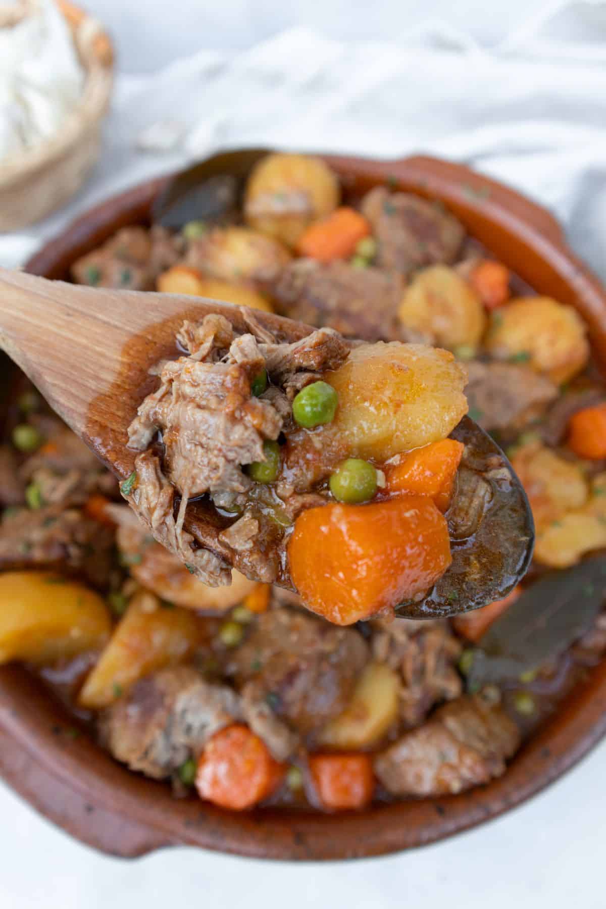Spanish beef stew with carrots, potatoes and peas
