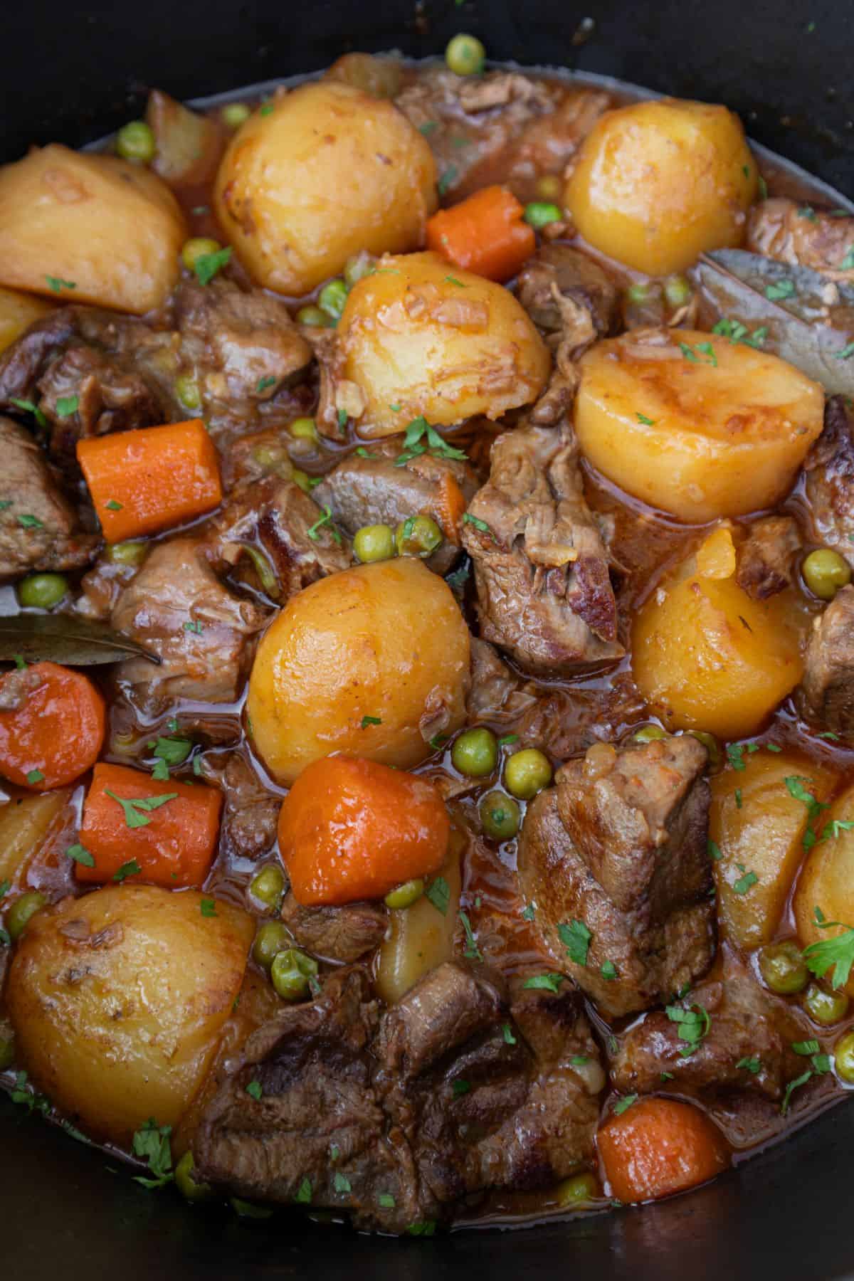 Spanish beef stew with potatoes, carrots and peas